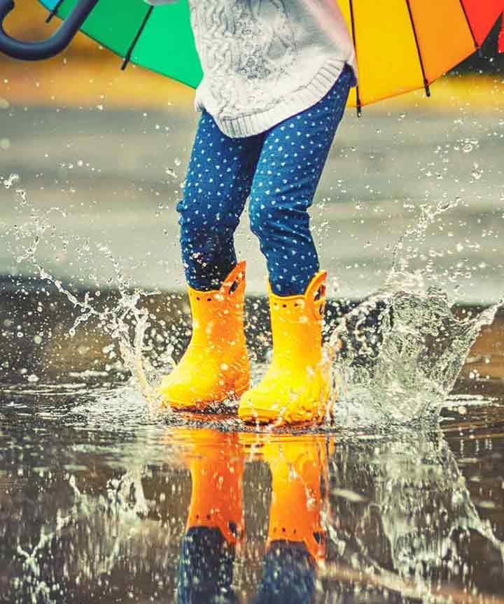 Child playing in the rain